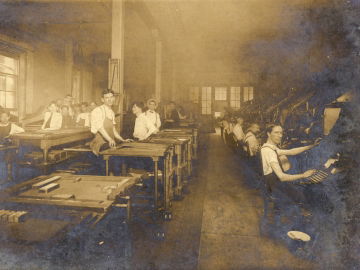 1906 composing room of the Atlanta Georgian depicting over a dozen men at various work stations