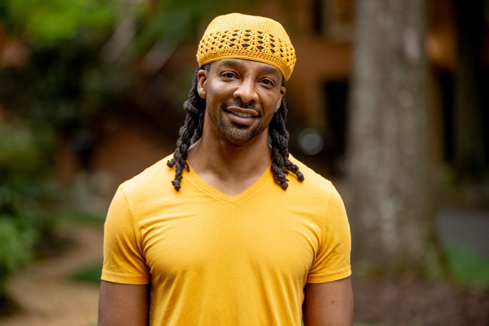 Jericho Brown in yellow shirt and hat